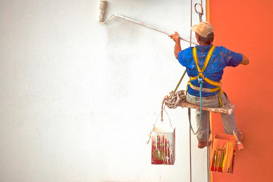 Pintor pintando una fachada de edificio